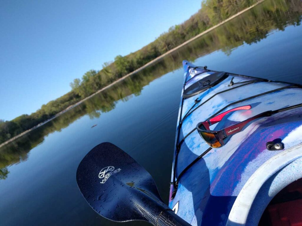 Vista panorámica con vistas a un lago mientras está sentado en un kayak con gafas de sol Bomber