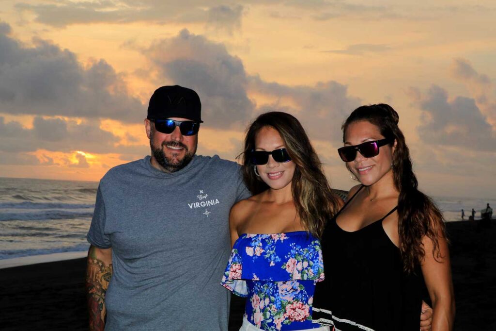 Group of friends wearing Bomber Floating Eyewear while enjoying a sunset on Hermosa Beach Costa Rica